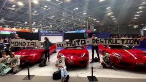 Climate activists glue themselves to sports cars