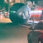 Moment huge Christmas bauble rolls down central London road as wind knocks it down