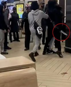 Shocking moment yobs brawl at McDonald’s before one pulls out a huge KNIFE in chaotic scenes