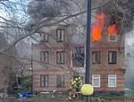 One dead as fire rips through flats in east London