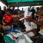 Nigeria tallies votes after tight presidential election hit by long delays