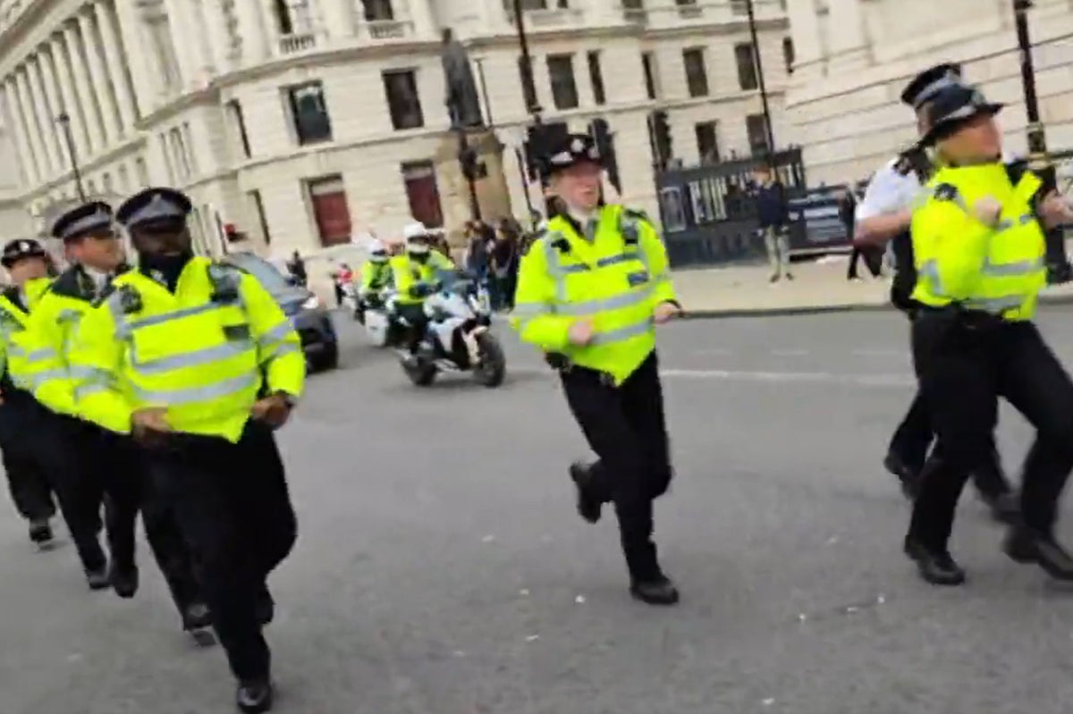 Dozens of jogging police officers escort Rishi Sunak’s car in huge motorcade through London