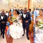 People react to trending video of a groom checking his phone while walking down the aisle with his wife