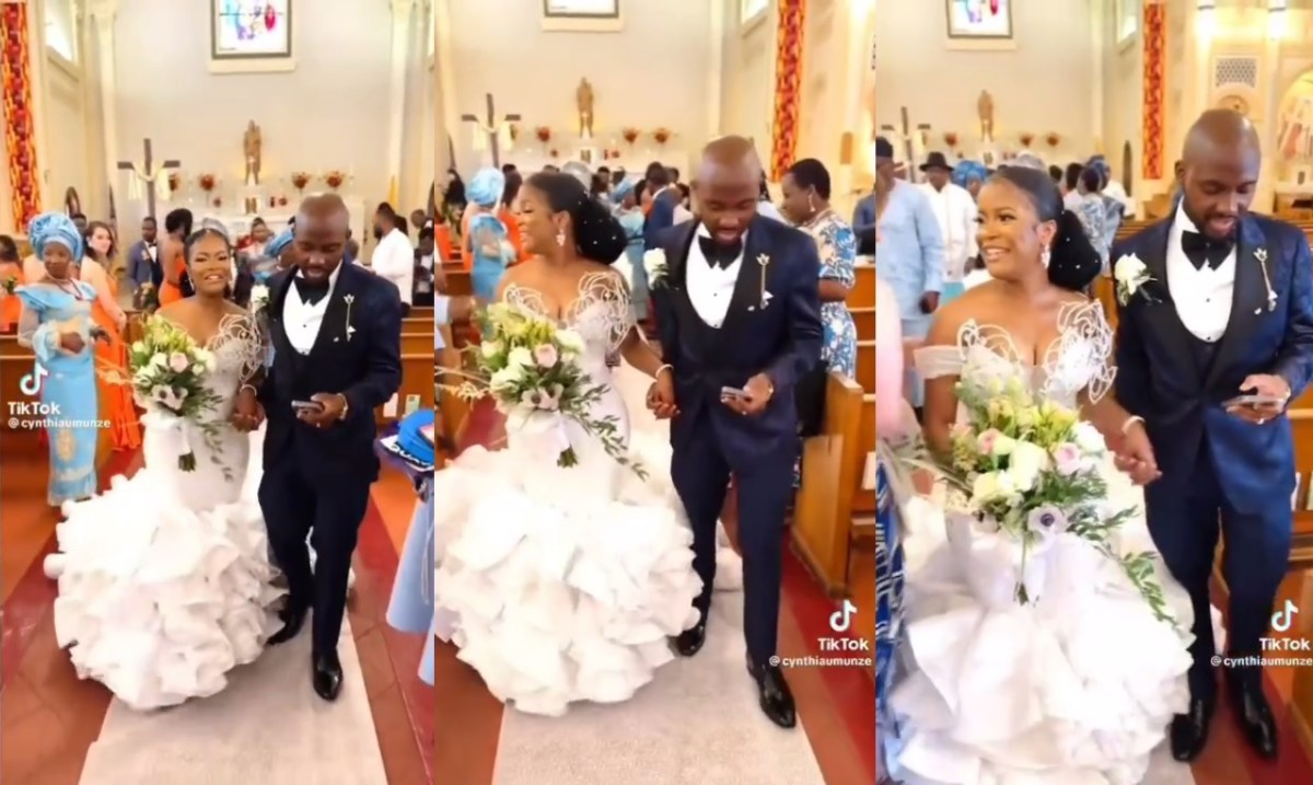 People react to trending video of a groom checking his phone while walking down the aisle with his wife