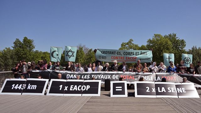 Religious figures, climate activists stage Paris protest against Total projects in Africa