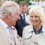 Queen Camilla rewears staple blue patterned dress with £630 trench coat for Dorset visit