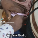 Ugandan cleric, Prophet Innocent âhealsâ a baby after âbringingâ out a yet-to-be identified object from her body (video)