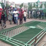 Violent NLC protesters pull down NASS gate in Abuja (video)