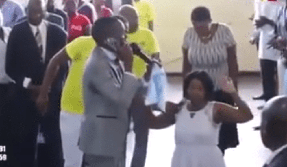 Watch a video of a PASTOR claiming that he is speaking to God on the phone during a live church service as his brainwashed congregants celebrate (VIDEO).