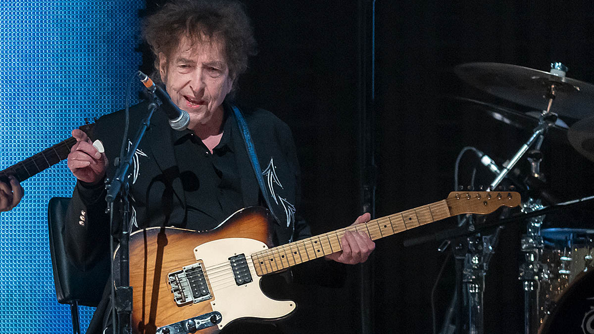 Watch Bob Dylan turn in a rare electric guitar performance as he surprises Farm Aid 2023 with the Heartbreakers backing him