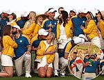 Jubilant Ryder Cup wags gather around Team Europe’s Viktor Hovland as they don matching yellow jackets to support their golf star partners on final day of competition