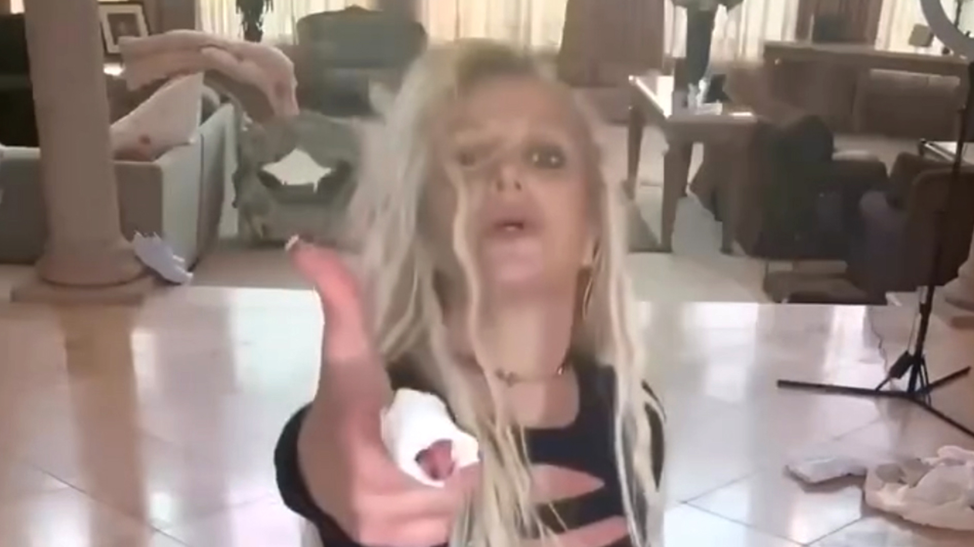 Britney Spears sparks more concern as she dances in a cast at trash-filled home in video she reposted after deleting