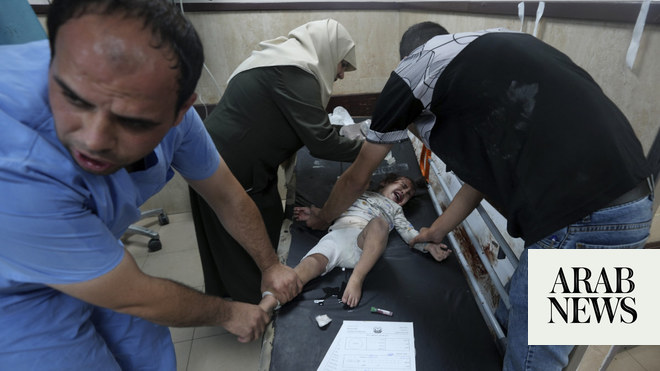 Bodies line Gaza hospital wall and surgeons operate in corridors