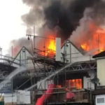 Dozens of firefighters called to battle blaze ripping through building as locals warned ‘keep windows closed’