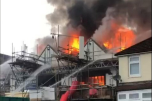Dozens of firefighters called to battle blaze ripping through building as locals warned ‘keep windows closed’