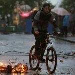 Thugs throw missiles on FOURTH night of violence as families forced to hide in attics in riots which injured 41 cops