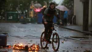 Thugs throw missiles on FOURTH night of violence as families forced to hide in attics in riots which injured 41 cops