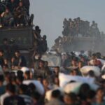 ‘Shells started falling’: Israeli tanks kill 59 people at Gaza aid site, local medics say