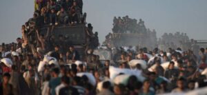 ‘Shells started falling’: Israeli tanks kill 59 people at Gaza aid site, local medics say
