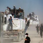 Under attack from all sides, armed clans try to protect aid coming into Gaza