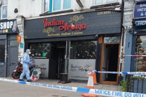 Boy, 15, and man arrested after fire attack on Indian restaurant in east London