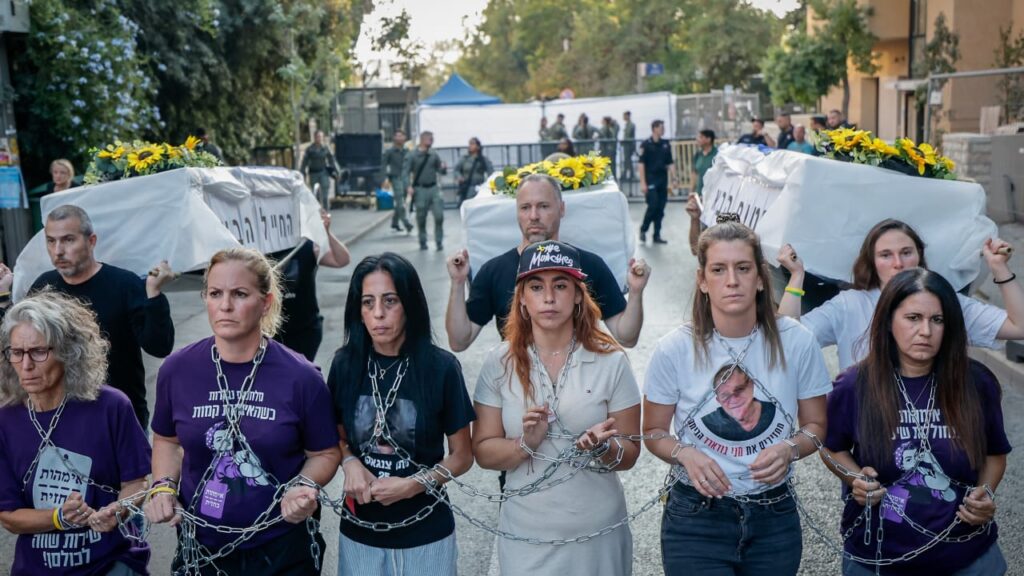 Einav Zangauker holds bottle of son’s urine from Gaza at hostage deal rally