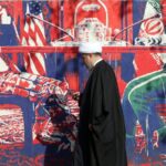 Iran warns of retaliation if Trump strikes, US withdraws some personnel from bases