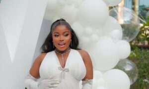 Veekee James’s White Maternity Gown Featured Opera Gloves and Crystal Details