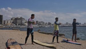Surfers in war-torn Gaza find rare moments of joy taking to the waves