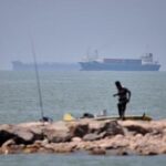 Iranian drones attack Bahrain and a ship is struck in the strait after US airstrikes