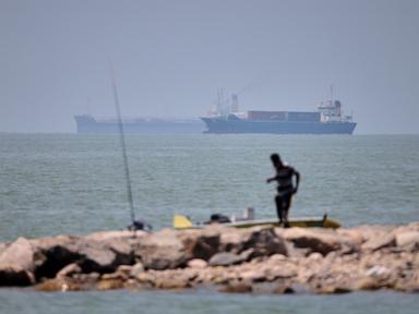 Iranian drones attack Bahrain and a ship is struck in the strait after US airstrikes